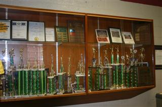 The trophy case displays team pictures and trophies from the intramural atheltics leagues.